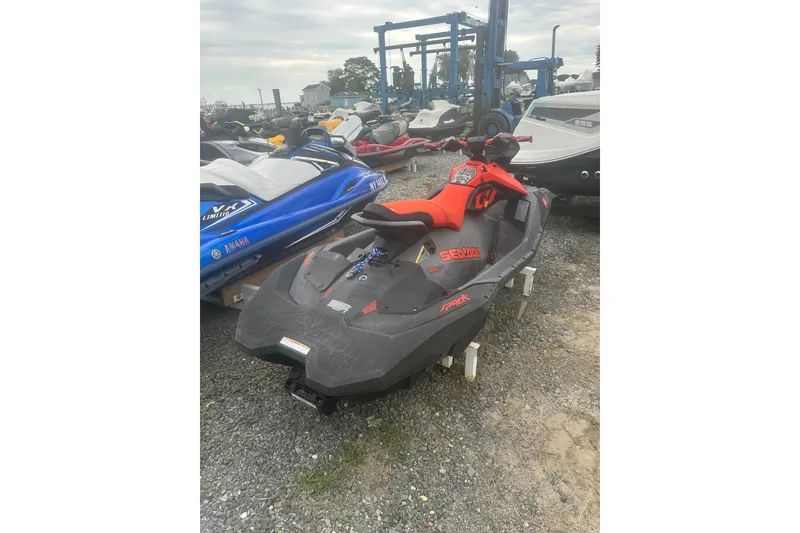 Slide: The Image of 2022 Sea-Doo Spark Trixx jet ski in a storage yard. - 8
