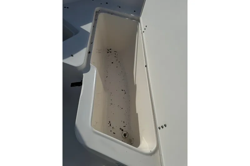 Slide: The Image of Open storage compartment on 2005 Sea Hunt Triton 220 boat, showing interior details. - 14
