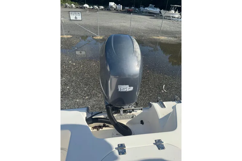 Slide: The Image of 2005 Sea Hunt Triton 220 boat with a 150 horsepower outboard motor. - 21