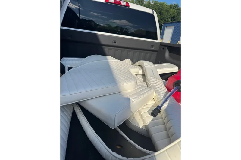 Slide: The Image of White boat cushions from a 2005 Sea Hunt Triton 220 in a truck bed. - 3