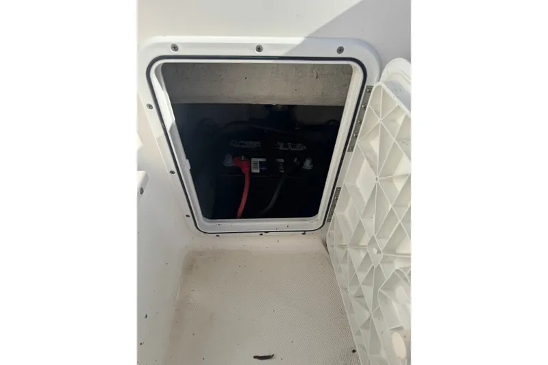 Slide: The Image of Battery compartment of a 2005 Sea Hunt Triton 220 boat, showing wiring and connections. - 7