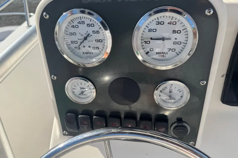 Slide: The Image of Dashboard of a 2005 Sea Hunt Triton 220 boat with speedometer and RPM gauges. - 12