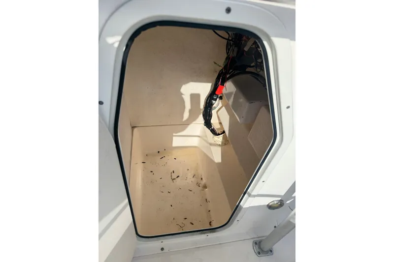 Slide: The Image of Storage compartment of a 2005 Sea Hunt Triton 220 boat, showing interior wiring. - 19