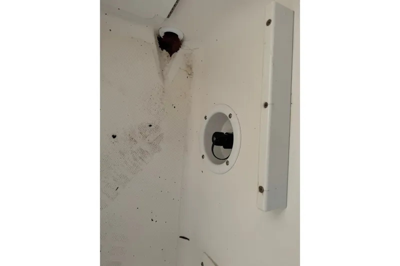 Slide: The Image of 2005 Sea Hunt Triton 220 interior detail showing a white panel with a circular fixture. - 8
