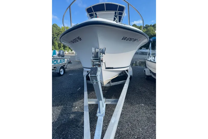 Slide: The Image of 2005 Sea Hunt Triton 220 boat on trailer, parked outdoors. - 2