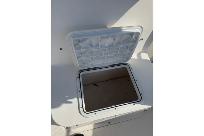 Slide: The Image of Open storage compartment on a 2005 Sea Hunt Triton 220 boat. - 16