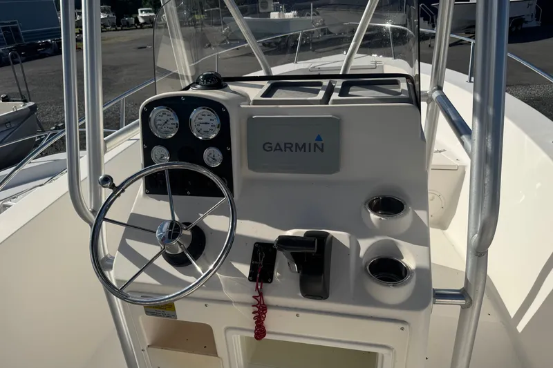 Slide: The Image of 2005 Sea Hunt Triton 220 boat console with Garmin navigation and steering wheel. - 13
