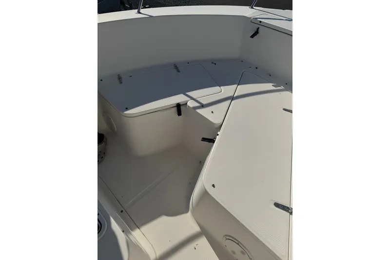 Slide: The Image of 2005 Sea Hunt Triton 220 boat interior with storage compartments and seating. - 17