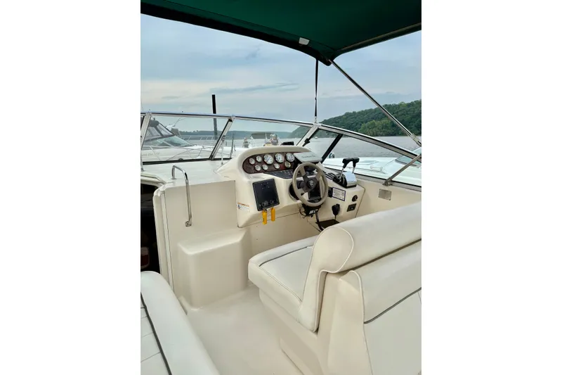 Slide: The Image of 1999 Monterey 296 Cruiser boat interior with steering wheel and dashboard controls. - 2