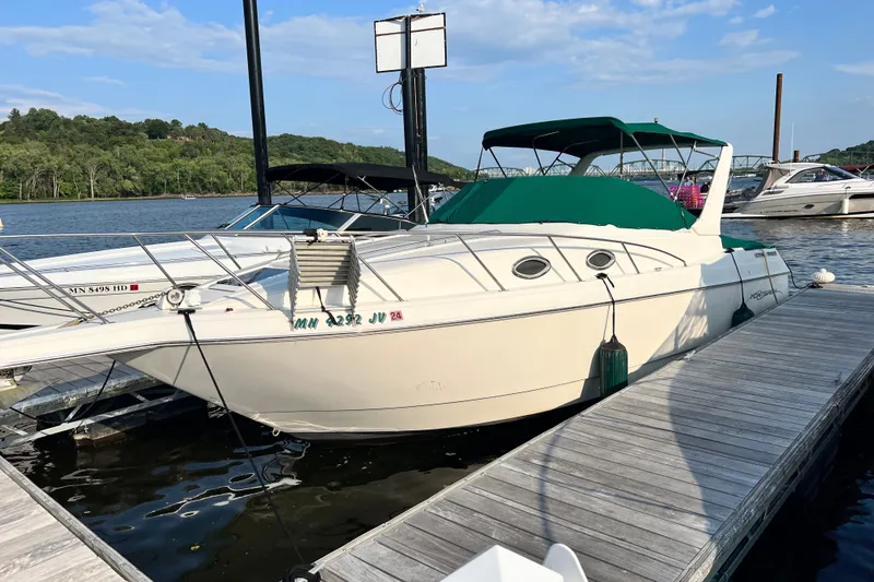 Slide: The Image of 1999 Monterey 296 Cruiser docked at a marina with green canopy. - 5