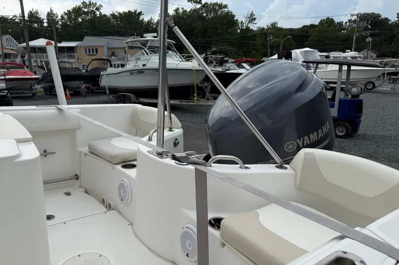 Slide: The Image of 2006 Boston Whaler 210 Outrage boat interior with Yamaha engine, docked in a marina. - 10