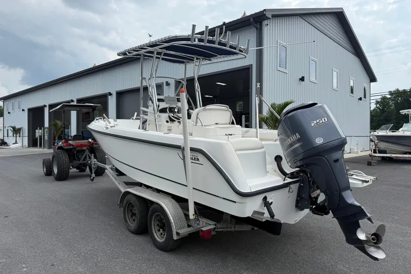 Slide: The Image of 2006 Boston Whaler 210 Outrage boat on trailer with Yamaha 250 engine, parked outside. - 3