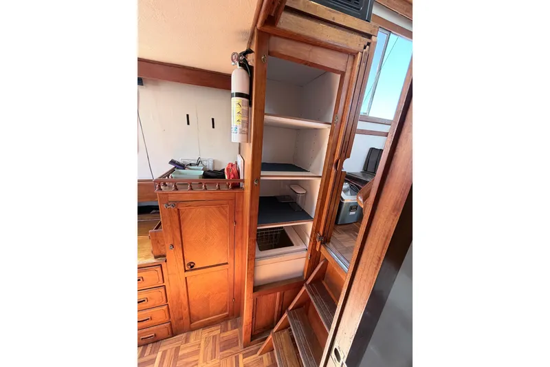 Slide: The Image of 1979 Marine Trader 36 interior with wooden cabinetry and storage shelves. - 17