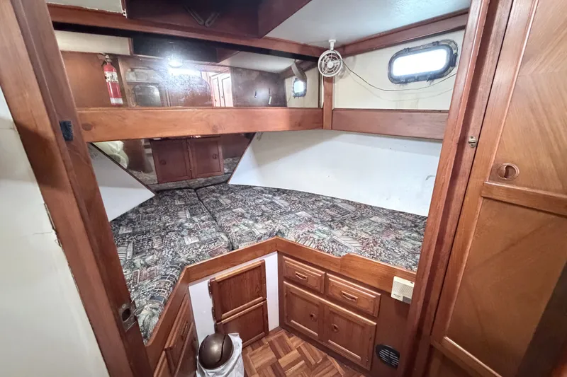 Slide: The Image of 1979 Marine Trader 36 cabin interior with wood finish and patterned bedding. - 28