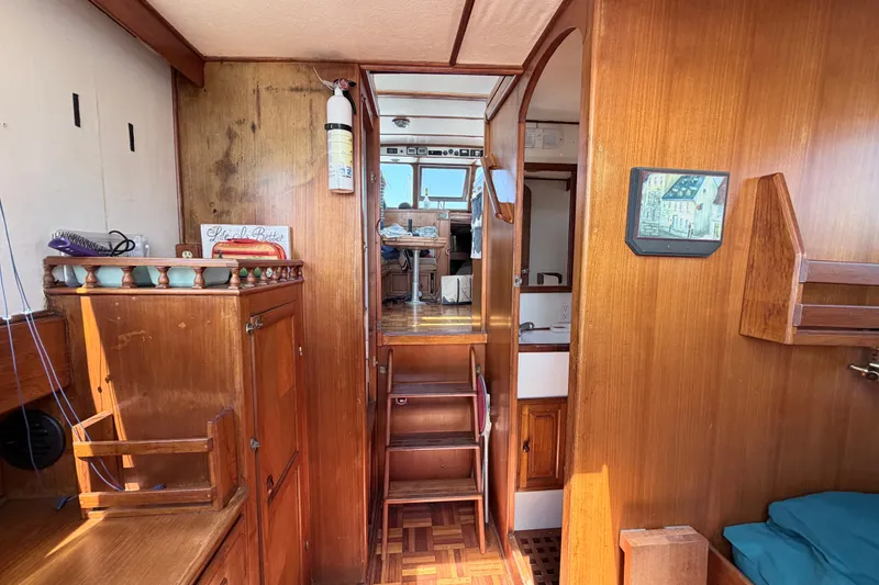 Slide: The Image of Interior of a 1979 Marine Trader 36 boat with wooden cabinetry and cozy decor. - 21