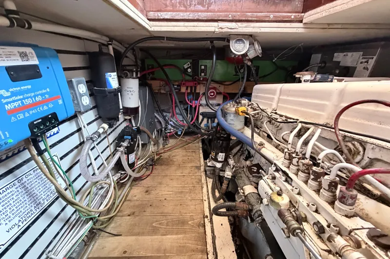 Slide: The Image of Engine room of a 1979 Marine Trader 36 with wiring and equipment. - 49