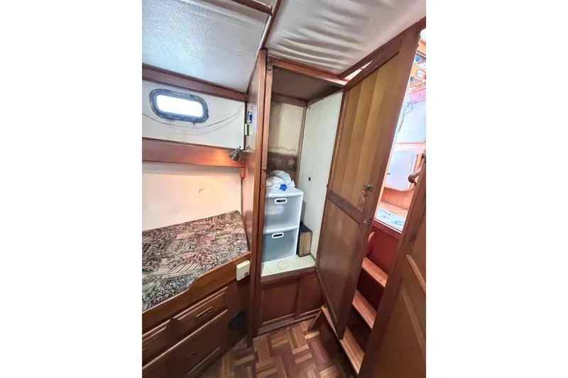 Slide: The Image of Cozy cabin interior of 1979 Marine Trader 36 with wooden furnishings and storage. - 20