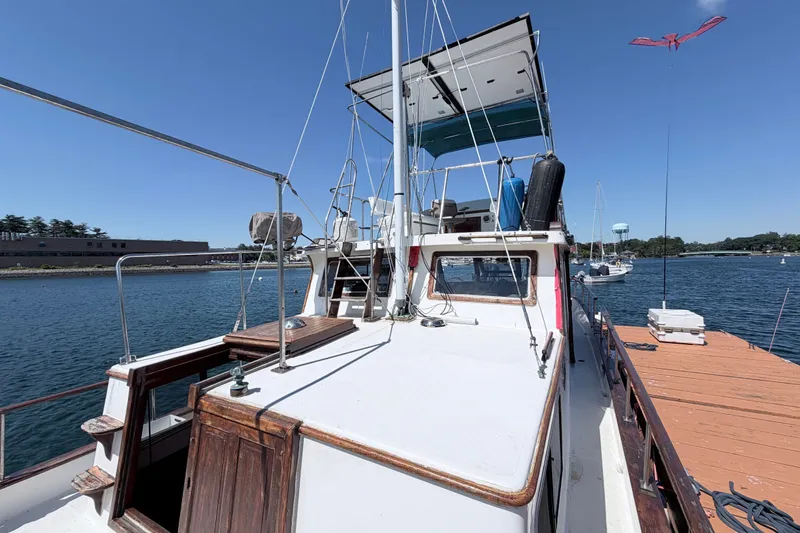 Slide: The Image of 1979 Marine Trader 36 yacht docked at a marina on a sunny day. - 38