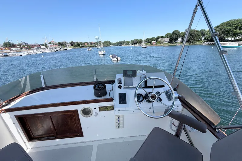 Slide: The Image of Helm of 1979 Marine Trader 36 boat with scenic marina view. - 39