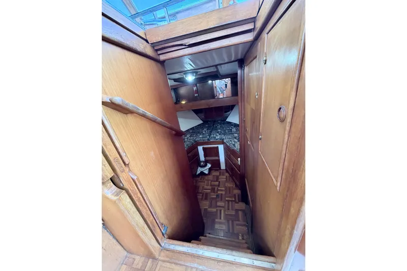 Slide: The Image of Interior view of 1979 Marine Trader 36 boat, featuring wooden stairs and cabin entrance. - 15