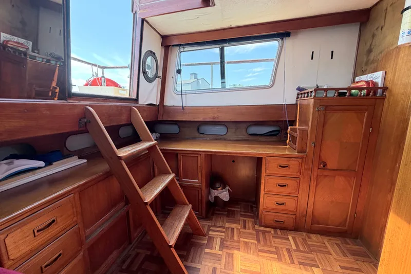 Slide: The Image of Interior of 1979 Marine Trader 36 boat with wooden cabinetry and ladder. - 14