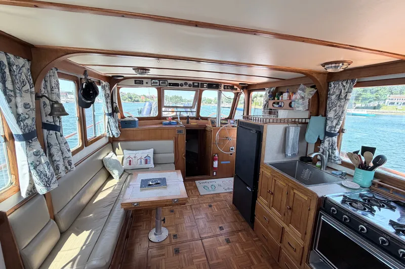 Slide: The Image of Interior of a 1979 Marine Trader 36 boat with kitchen and seating area. - 42