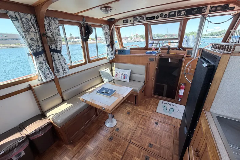 Slide: The Image of 1979 Marine Trader 36 interior with wood paneling, seating, and nautical decor. - 45
