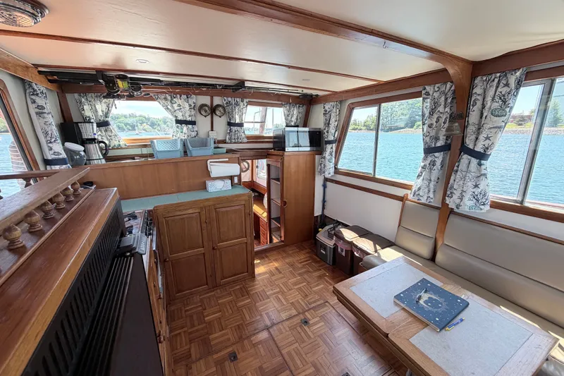 Slide: The Image of Interior of a 1979 Marine Trader 36 yacht with wood accents and scenic water views. - 46