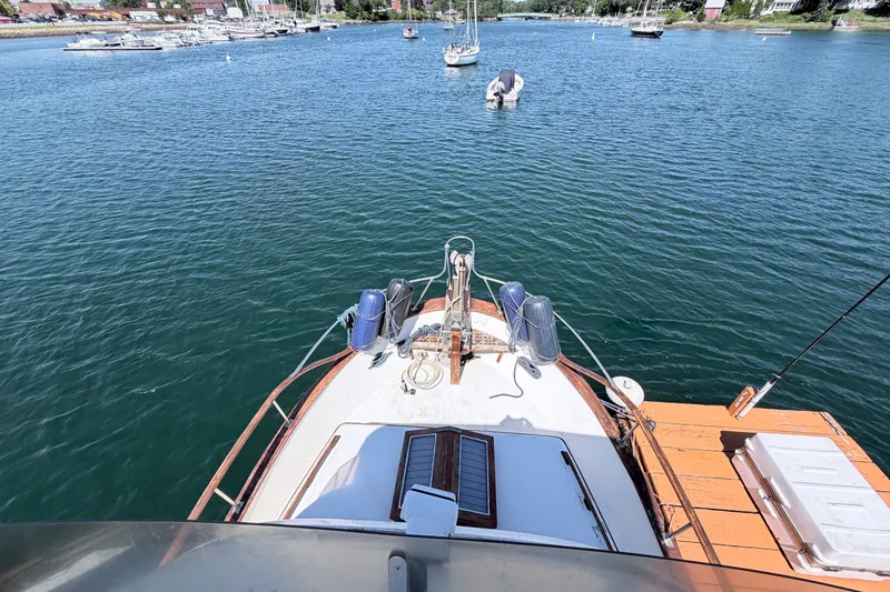 Slide: The Image of 1979 Marine Trader 36 yacht docked in a serene marina with sailboats. - 41