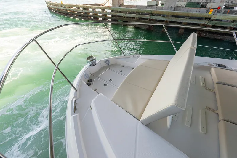 Slide: The Image of Manufacturer Provided Image: 2026 Regal 38 FXO boat with cushioned seating, docked near a wooden pier. - 8