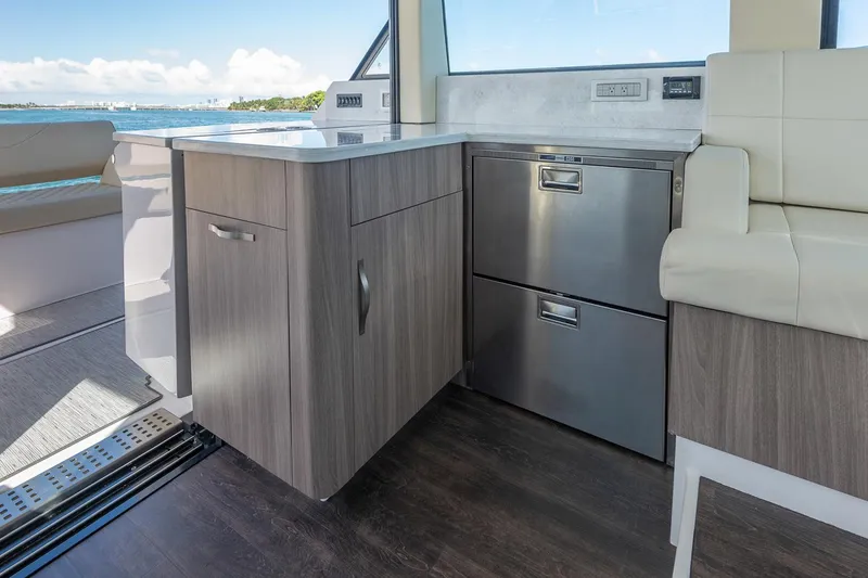 Slide: The Image of Manufacturer Provided Image: Modern kitchen area on 2026 Regal 38 FXO yacht with sleek cabinetry and stainless steel appliances. - 15