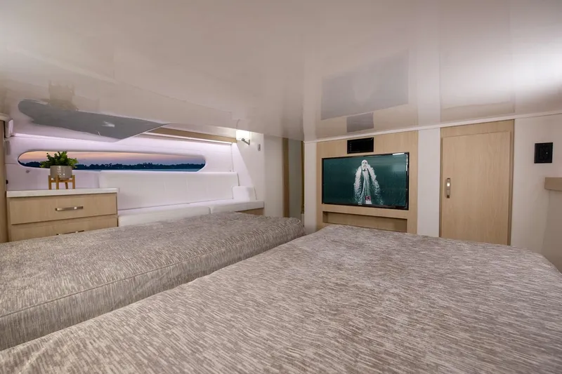 Slide: The Image of Manufacturer Provided Image: Luxurious interior of 2026 Regal 38 FXO yacht with twin beds and modern decor. - 22