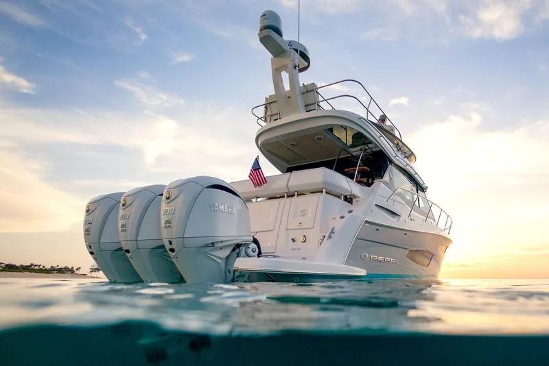 Slide: The Image of Manufacturer Provided Image: 2026 Regal 38 FXO yacht with triple engines, cruising at sunset. - 7