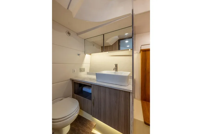 Slide: The Image of Manufacturer Provided Image: Modern bathroom in 2026 Regal 38 SAV yacht with sleek sink and wooden cabinetry. - 14