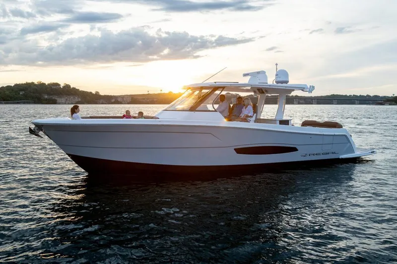 The Image of Manufacturer Provided Image: 2026 Regal 38 Surf boat cruising at sunset on a serene lake. - 3