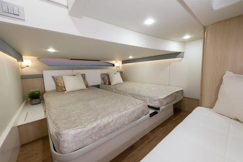 Slide: The Image of Manufacturer Provided Image: Luxurious cabin interior of 2026 Regal 42 XO yacht with twin beds and modern decor. - 13