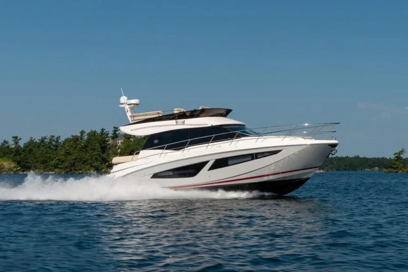 The Image of Manufacturer Provided Image: 2026 Regal 42 Fly yacht cruising on a sunny day, surrounded by water and trees. - 0