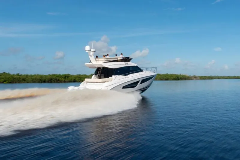 The Image of Manufacturer Provided Image: 2026 Regal 42 FXO yacht cruising on calm waters under a clear blue sky. - 0