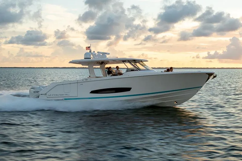 The Image of Manufacturer Provided Image: 2026 Regal 43 SAV boat cruising on water at sunset. - 1