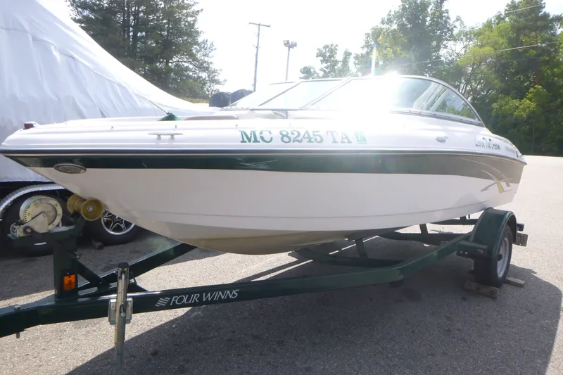 Slide: The Image of 2007 Four Winns 180 Horizon boat on trailer, parked outdoors in sunny setting. - 2