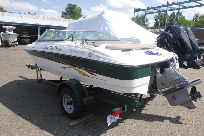 Slide: The Image of 2007 Four Winns 180 Horizon boat on trailer in outdoor storage area. - 3