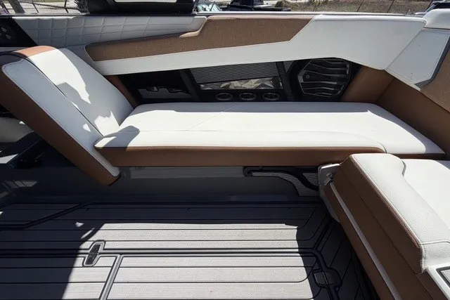 Slide: The Image of 2022 Nautique Super Air Nautique G25 interior seating with brown and white upholstery. - 20