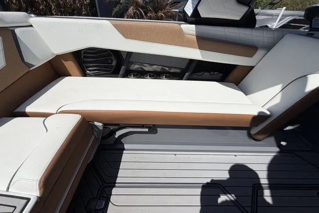 Slide: The Image of 2022 Nautique Super Air Nautique G25 interior seating with white and tan upholstery. - 21
