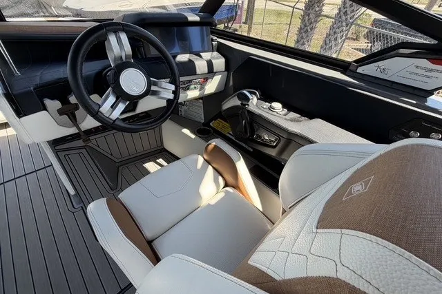 Slide: The Image of Interior of 2022 Nautique Super Air Nautique G25 boat, featuring modern steering and seating. - 16