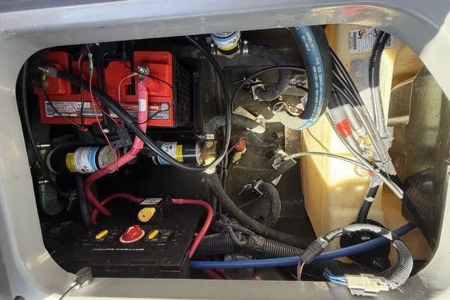 Slide: The Image of Engine compartment of 2022 Nautique Super Air Nautique G25 with visible wiring and components. - 22
