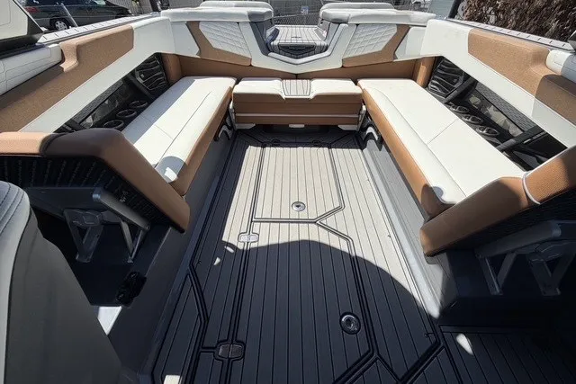 Slide: The Image of 2022 Nautique Super Air Nautique G25 interior with spacious seating and modern design. - 18