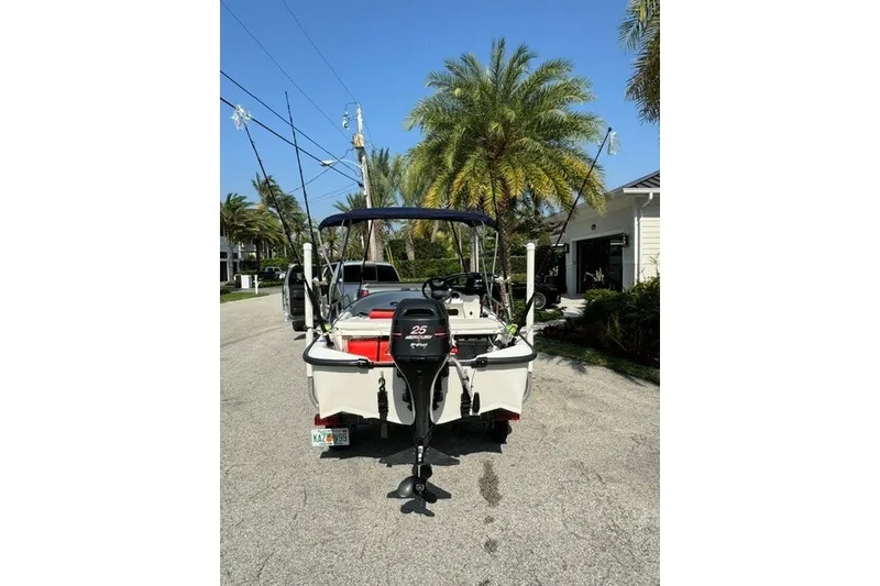 Slide: The Image of 2000 Boston Whaler Sport 13 boat with Mercury 25 outboard motor on a sunny street. - 11