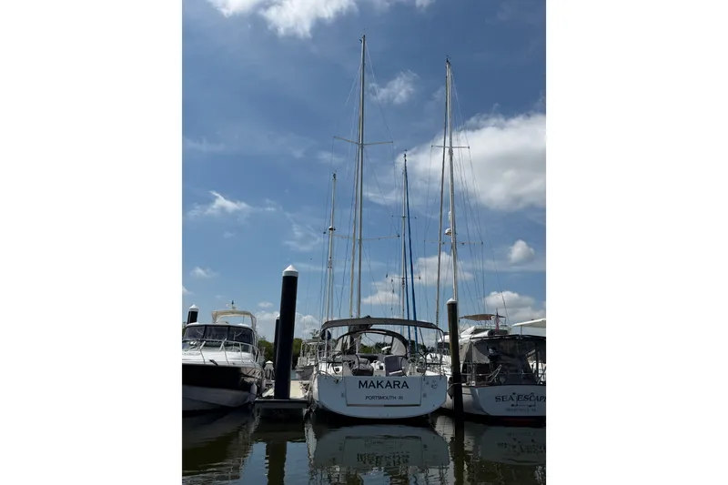 Slide: The Image of Jeanneau Sun Odyssey 410 sailboat docked at marina, 2022 model, under clear blue sky. - 27