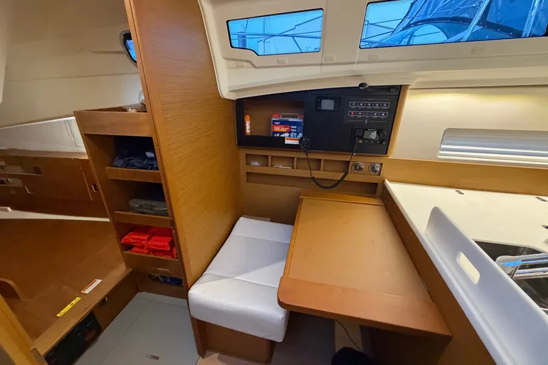 Slide: The Image of Interior of 2022 Jeanneau Sun Odyssey 410 sailboat, featuring navigation station and seating area. - 31