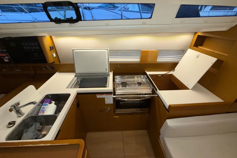 Slide: The Image of Modern kitchen interior of 2022 Jeanneau Sun Odyssey 410 yacht, featuring stove and sink. - 36
